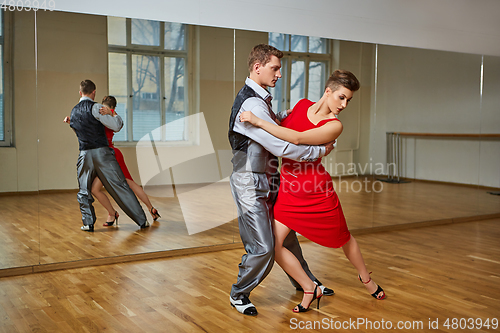 Image of beautiful couple dancing tango