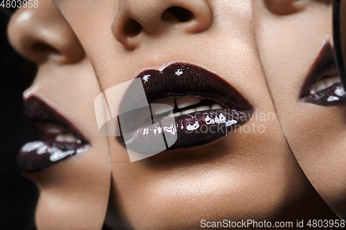 Image of beautiful woman lips closeup with mirror reflections