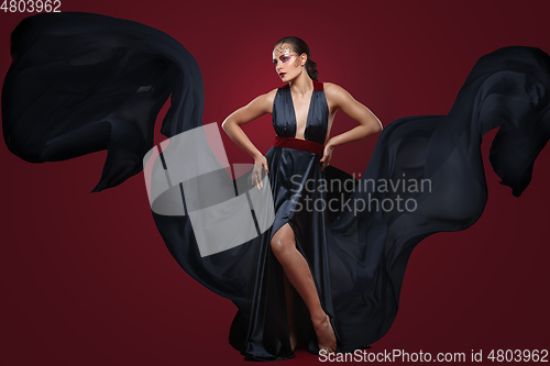 Image of beautiful woman in flying silk dress