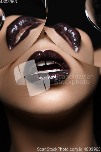 Image of beautiful woman lips closeup with mirror reflections