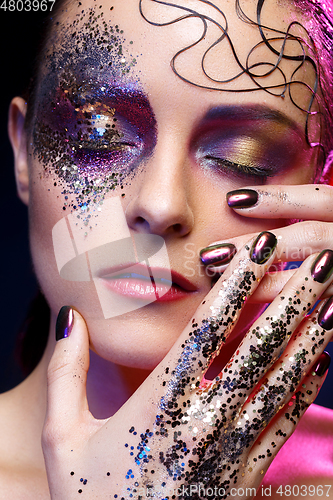 Image of beautiful woman with bright makeup with glitter