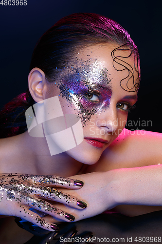 Image of beautiful woman with bright makeup with glitter