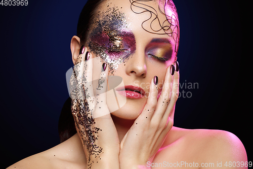 Image of beautiful woman with bright makeup with glitter