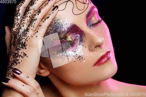 Image of beautiful woman with bright makeup with glitter