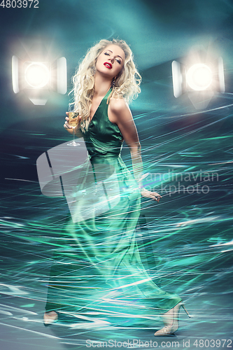 Image of beautiful girl in evening dress surrounded by light