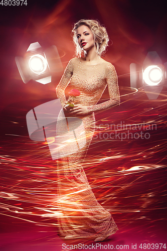 Image of beautiful girl in evening dress surrounded by light