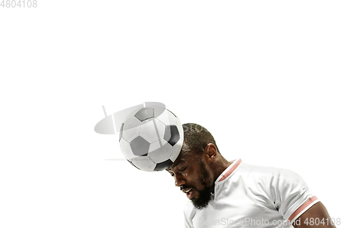 Image of Close up of emotional man playing soccer hitting the ball with the head on isolated white background