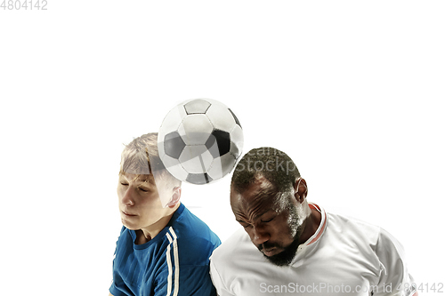 Image of Close up of emotional men playing soccer hitting the ball with the head on isolated on white background