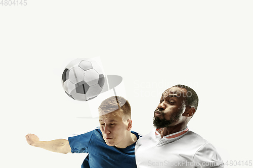 Image of Close up of emotional men playing soccer hitting the ball with the head on isolated on white background