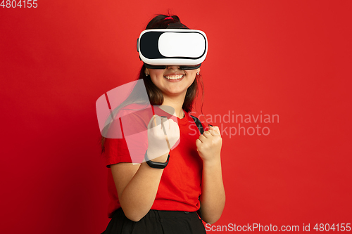 Image of Asian teenager\'s portrait isolated on red studio background