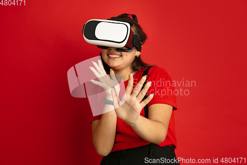 Image of Asian teenager\'s portrait isolated on red studio background