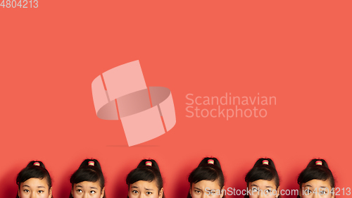 Image of Asian teenager\'s portrait isolated on red studio background