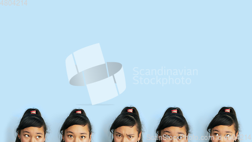 Image of Asian teenager\'s portrait isolated on blue studio background