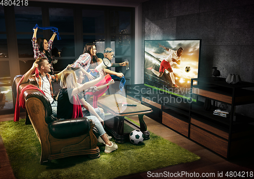 Image of Group of friends watching TV, football match, sport together