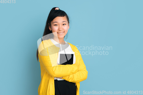 Image of Asian teenager\'s portrait isolated on blue studio background