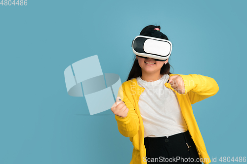 Image of Asian teenager\'s portrait isolated on blue studio background