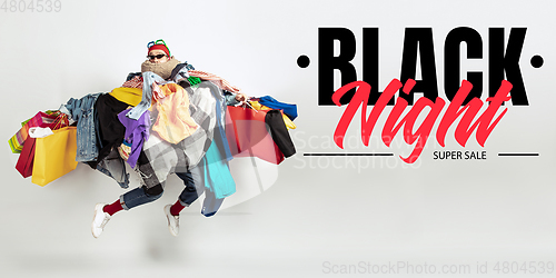 Image of Man addicted of sales and clothes, black night, sales concept