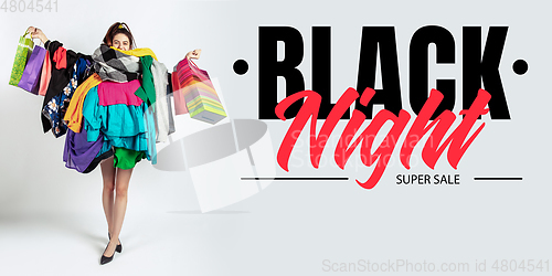 Image of Woman addicted of sales and clothes, black night, sales concept