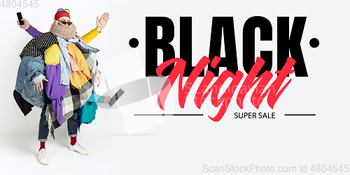 Image of Man addicted of sales and clothes, black night, sales concept