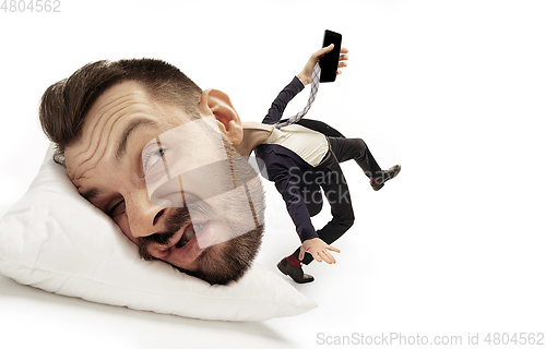 Image of Big head on small body lying on the pillow