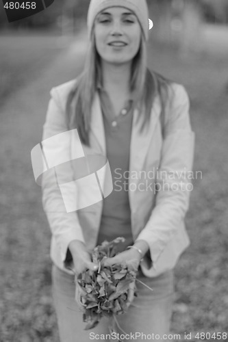 Image of woman holding leaves