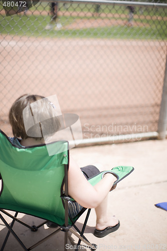 Image of woman watching baseball