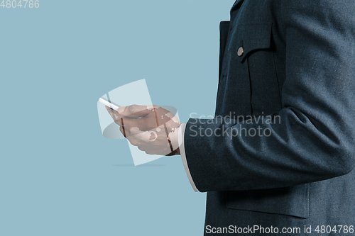 Image of Close up of male hands with vitiligo pigments isolated on blue studio background