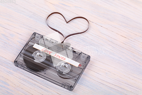 Image of Audio cassette tape on wooden background. audio film shaping hea