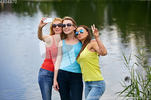 Image of three girls having fun outdoors