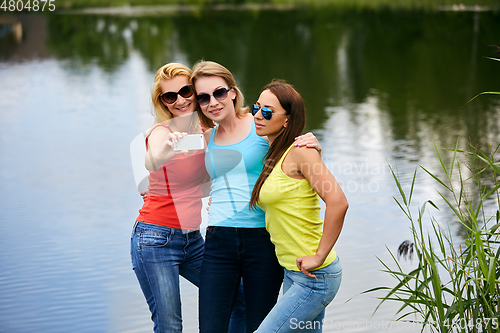 Image of three girls having fun outdoors
