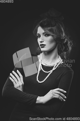 Image of beautiful girl with pearl necklace and veil hat