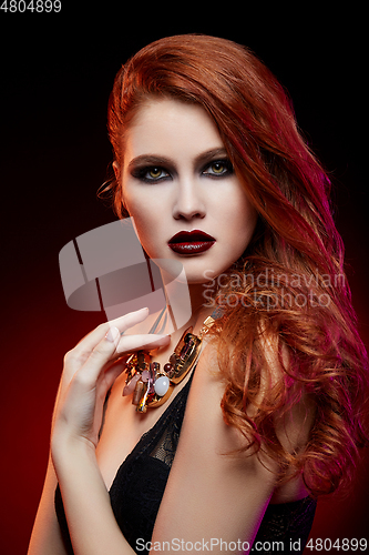 Image of beautiful girl with bright makeup and red hair