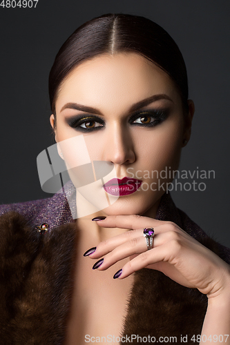 Image of beautiful young woman with dark makeup