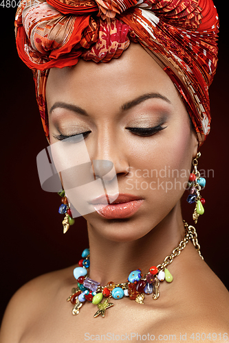 Image of beautiful mulatto young woman with turban on head