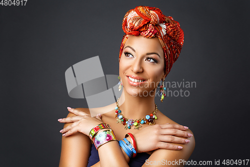 Image of beautiful mulatto young woman with turban on head