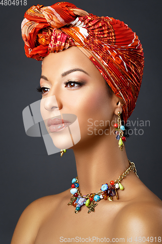 Image of beautiful mulatto young woman with turban on head