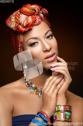 Image of beautiful mulatto young woman with turban on head