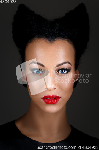 Image of girl with bright makeup and horns hairstyle