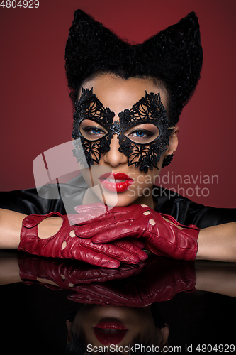 Image of girl with horns hairstyle in leather mask