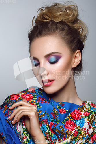 Image of beautiful girl with bright makeup in russian shawl