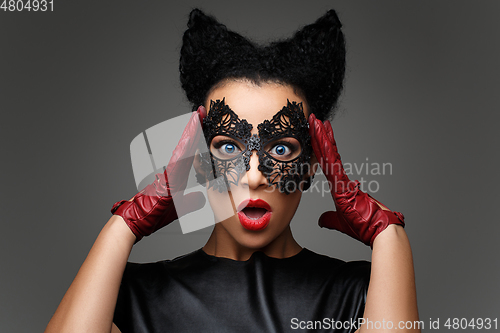 Image of girl with horns hairstyle in leather mask