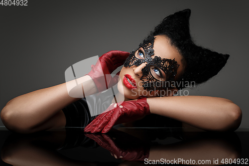 Image of girl with horns hairstyle in leather mask