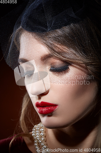 Image of beautiful girl with pearl necklace and veil hat