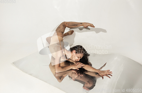 Image of Young and stylish modern ballet dancer on white background with mirrors