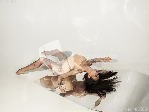 Image of Young and stylish modern ballet dancer on white background with mirrors