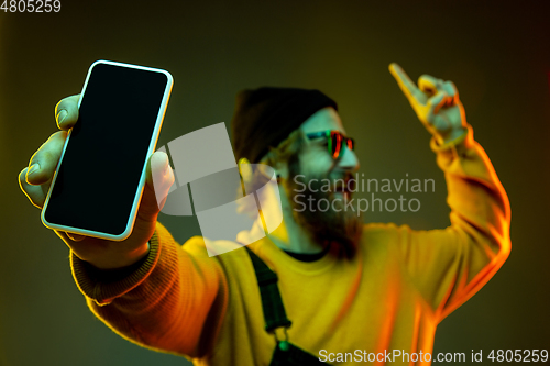 Image of Caucasian man\'s portrait isolated on gradient studio background in neon light