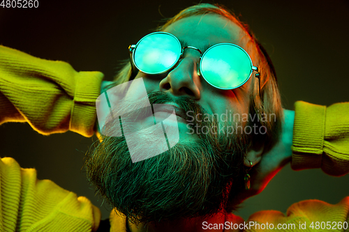 Image of Caucasian man\'s portrait isolated on gradient studio background in neon light