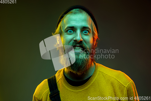 Image of Caucasian man\'s portrait isolated on gradient studio background in neon light