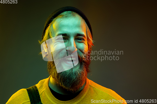 Image of Caucasian man\'s portrait isolated on gradient studio background in neon light