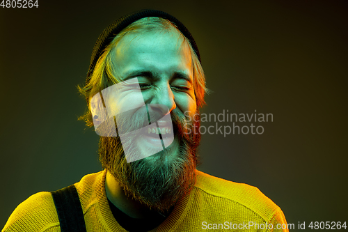 Image of Caucasian man\'s portrait isolated on gradient studio background in neon light